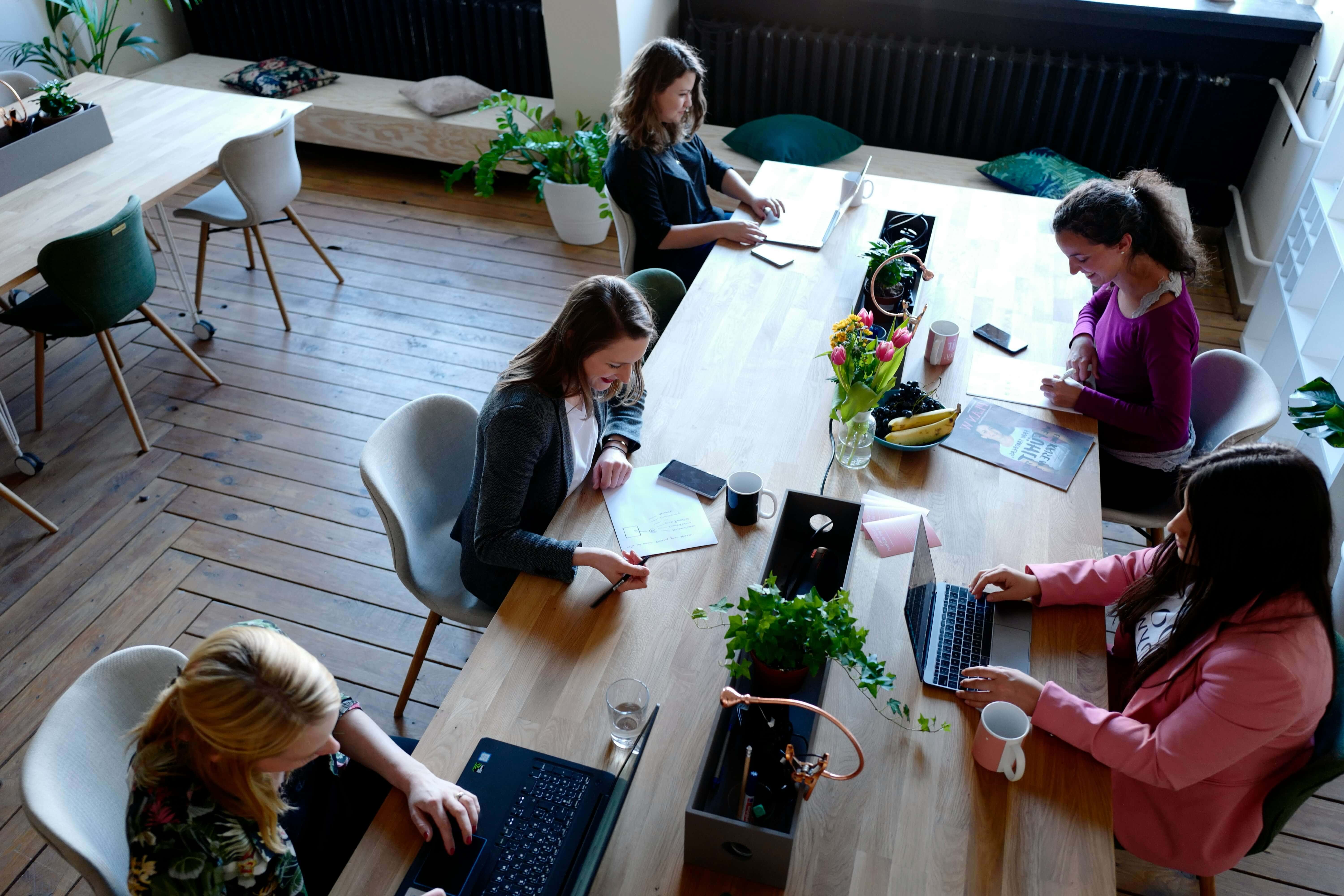 A team of colleagues collaborating and talking around a table